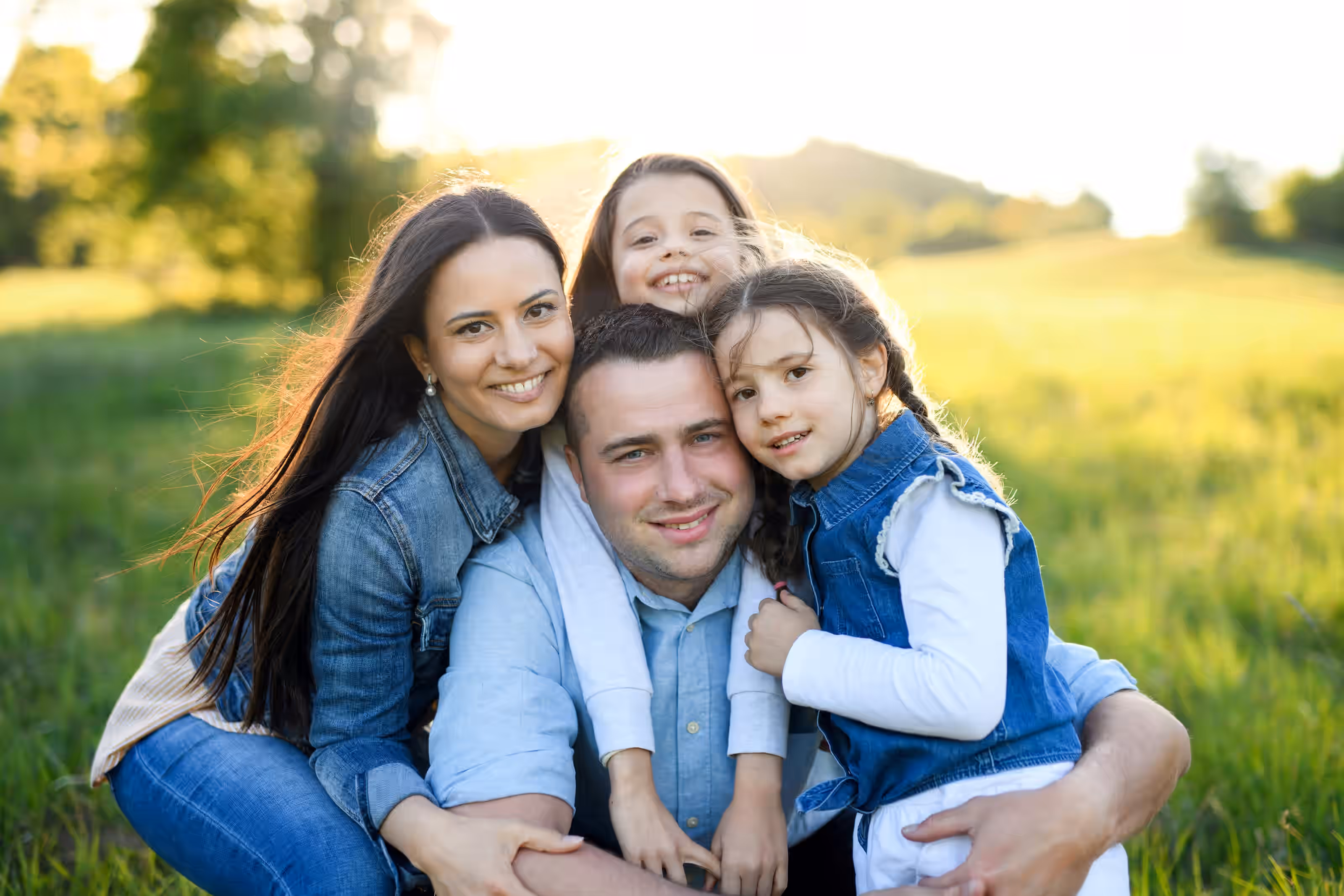 Family smiles on a couch for a picture together
