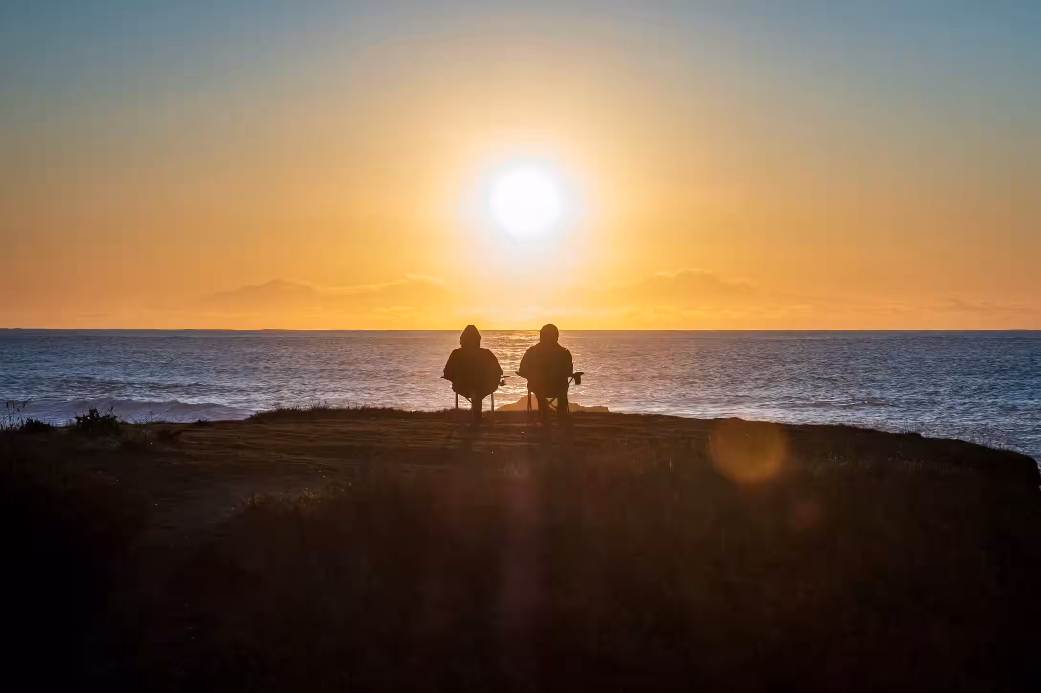 couple overlooking the sunset as they relax